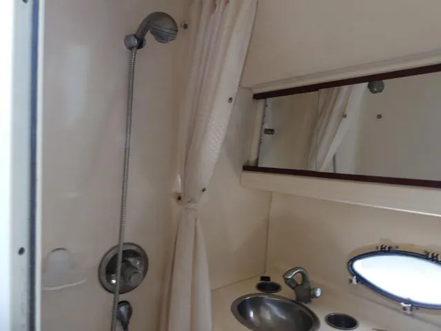 Slide: The Image of 2005 Larson 330 CABRIO boat bathroom with shower, sink, and mirror. - 25