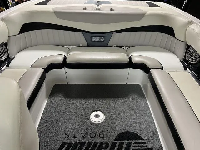 Slide: The Image of 2014 Malibu Wakesetter 22 MXZ interior with sleek seating and branded flooring. - 10