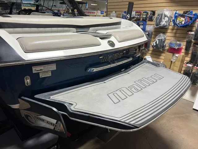 Slide: The Image of 2014 Malibu Wakesetter 22 MXZ boat rear view in showroom with swim platform. - 11
