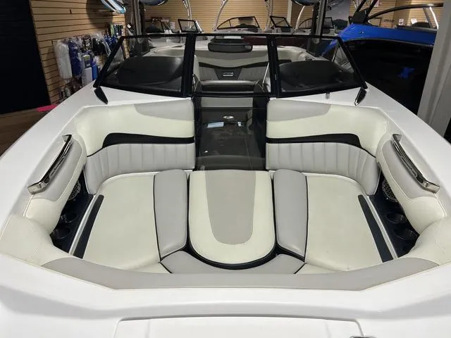 Slide: The Image of 2014 Malibu Wakesetter 22 MXZ boat interior with white and gray seating. - 5