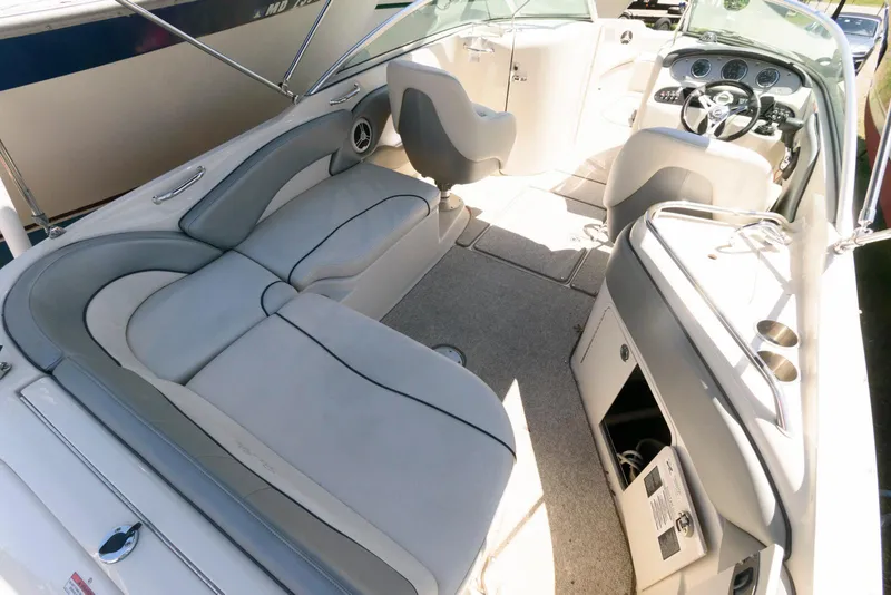 Slide: The Image of 2009 Sea Ray 240 Sundeck interior with spacious seating and modern dashboard. - 10