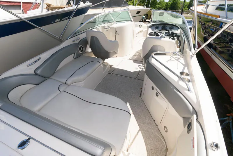 Slide: The Image of 2009 Sea Ray 240 Sundeck boat interior with spacious seating and modern dashboard. - 2