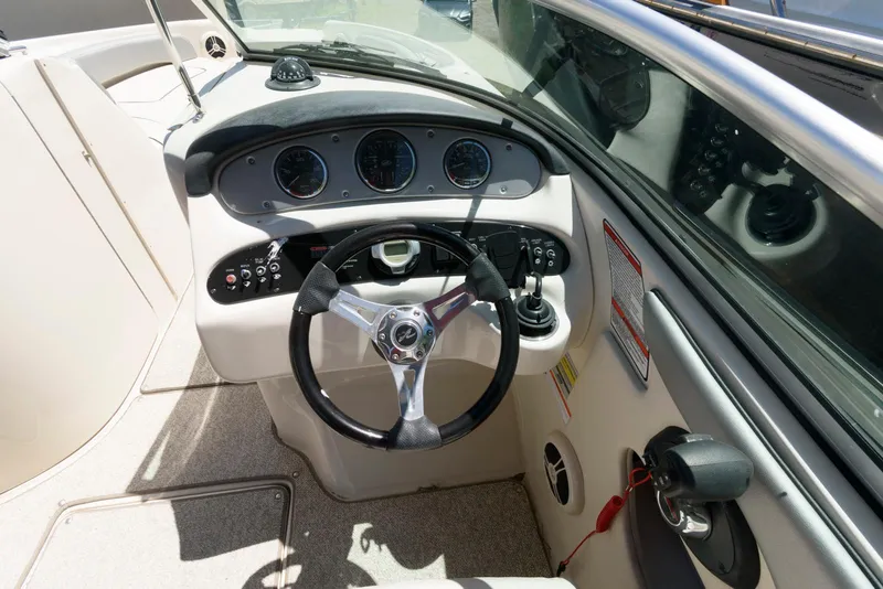 Slide: The Image of 2009 Sea Ray 240 Sundeck boat dashboard with steering wheel and instrument panel. - 8