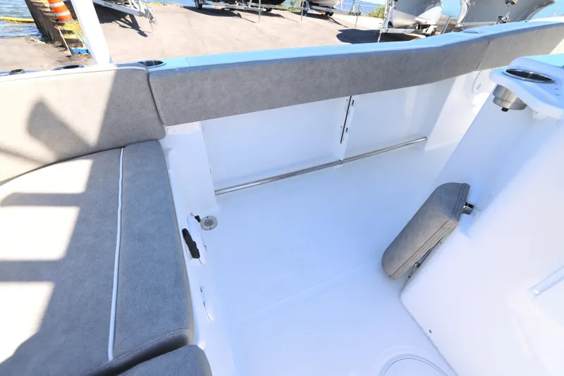 Slide: The Image of 2025 Sea Hunt Ultra 239 SE boat interior with cushioned seating and storage. - 12