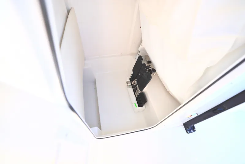 Slide: The Image of Interior compartment of 2025 Sea Hunt Ultra 239 SE boat, featuring storage space. - 15