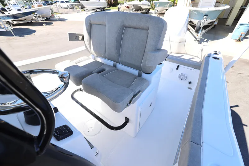 Slide: The Image of 2025 Sea Hunt Ultra 239 SE boat interior with gray seating and steering wheel. - 16