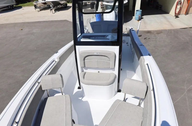Slide: The Image of 2025 Sea Hunt Ultra 239 SE boat interior with seating and console. - 18