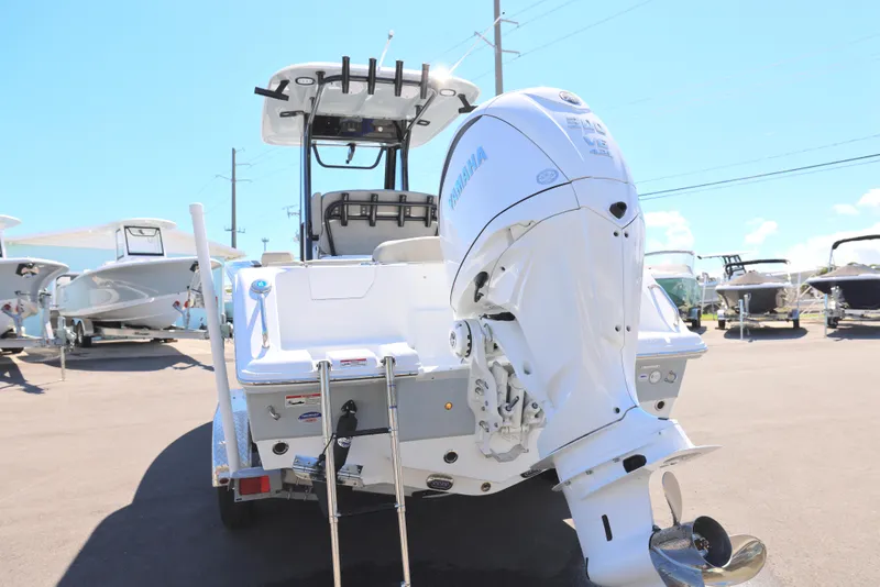 Slide: The Image of 2025 Sea Hunt Ultra 239 SE boat with powerful outboard motor, displayed outdoors. - 2