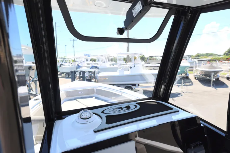 Slide: The Image of 2025 Sea Hunt Ultra 239 SE boat interior view at a marina. - 20