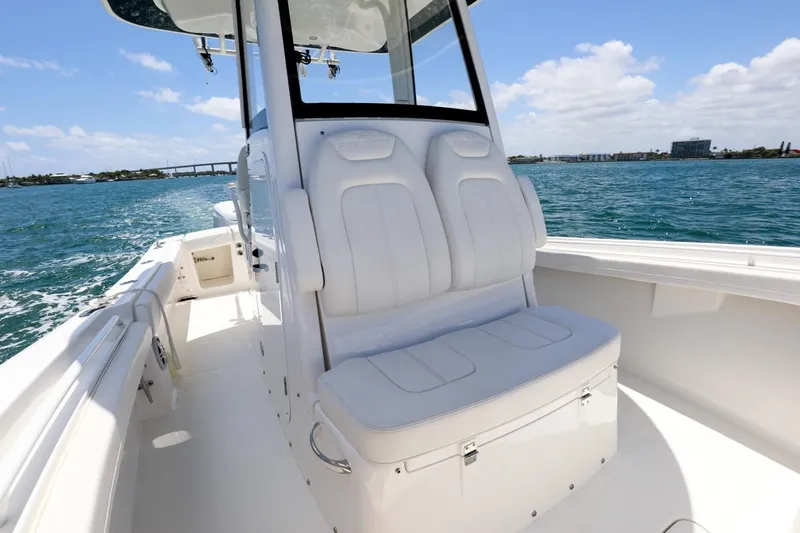 Slide: The Image of 2024 Regulator 23 boat with white seating, cruising on a sunny day. - 12