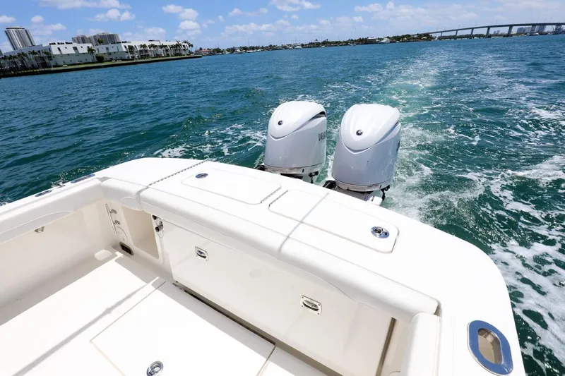 Slide: The Image of 2024 Regulator 23 boat cruising on open water with twin engines. - 13