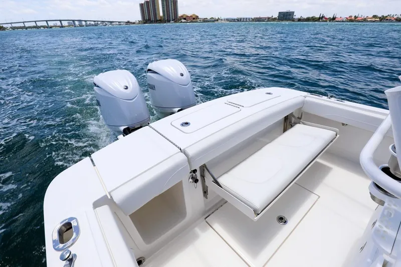 Slide: The Image of 2024 Regulator 23 boat with dual engines on open water. - 14