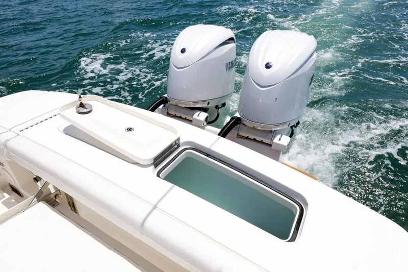 Slide: The Image of 2024 Regulator 23 boat with dual engines on open water. - 15