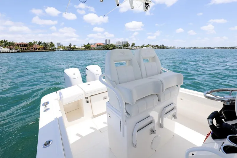 Slide: The Image of 2024 Regulator 23 boat with dual seats on a sunny day at sea. - 26