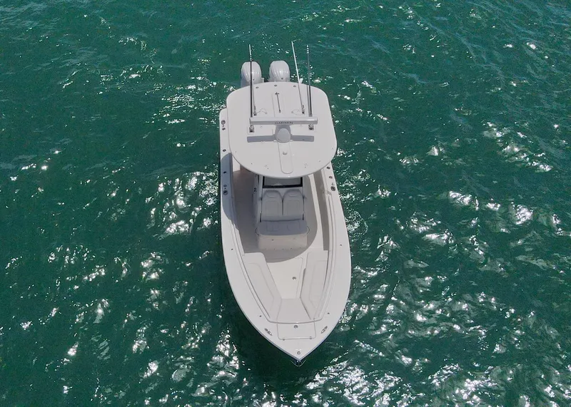 Slide: The Image of 2024 Regulator 23 boat on clear blue water, aerial view. - 29
