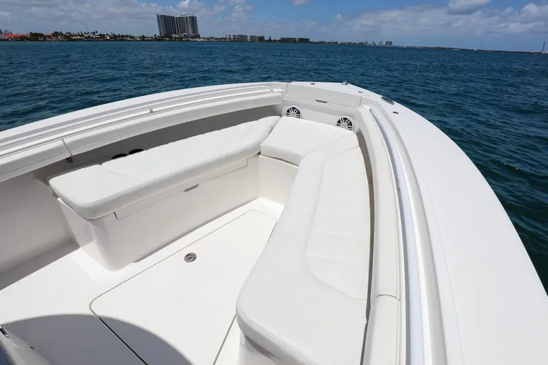 Slide: The Image of 2024 Regulator 23 boat with spacious seating, cruising on a sunny day. - 4