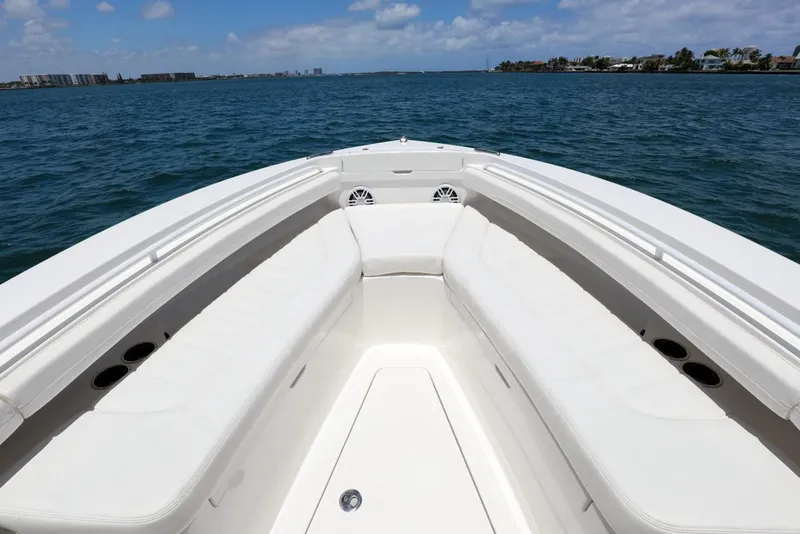 Slide: The Image of 2024 Regulator 23 boat bow with seating, on a sunny day at sea. - 5