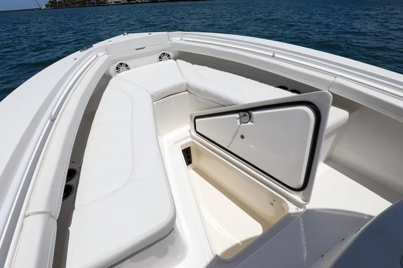 Slide: The Image of 2024 Regulator 23 boat interior with open storage compartment and cushioned seating. - 8