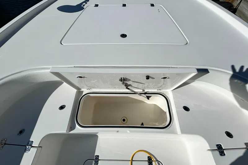 Slide: The Image of 2021 Caymas 28 HB boat deck with storage compartment open. - 14