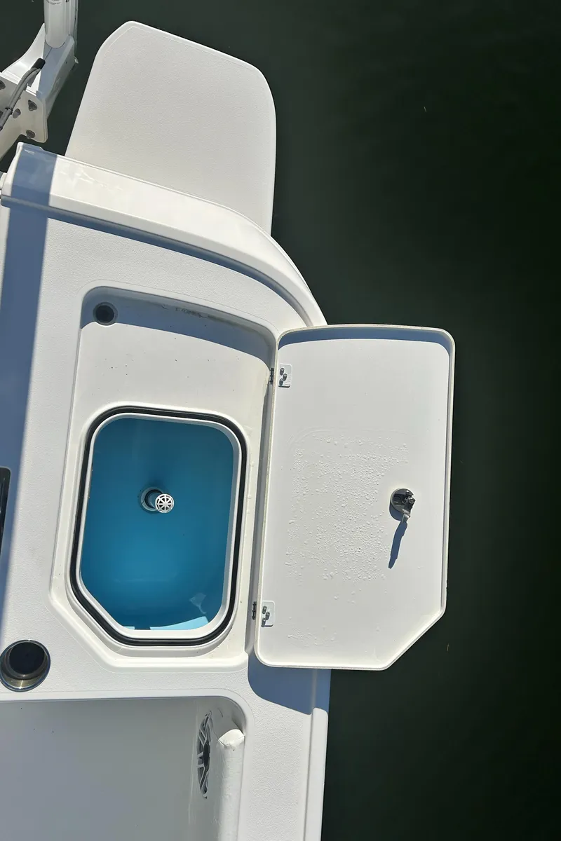 Slide: The Image of 2021 Caymas 28 HB boat with open storage compartment on deck. - 16