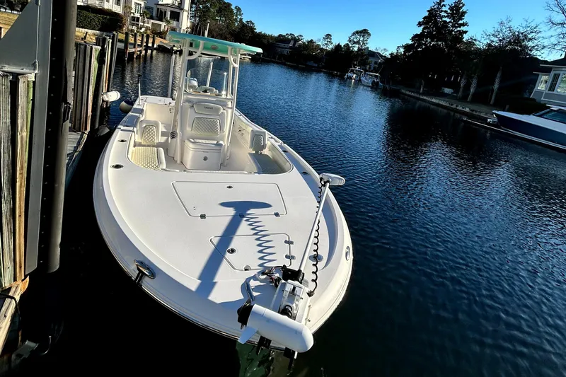 Slide: The Image of 2021 Caymas 28 HB boat docked on a calm waterfront. - 2