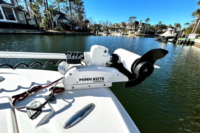 Slide: The Image of 2021 Caymas 28 HB boat with Minn Kota Terrova trolling motor on a scenic waterfront. - 20