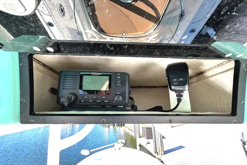 Slide: The Image of 2021 Caymas 28 HB boat console with marine radio and microphone. - 27