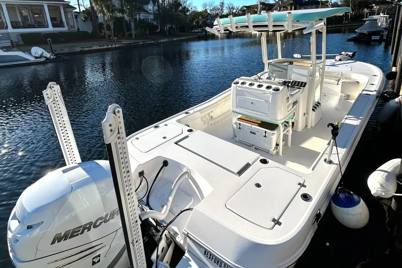 Slide: The Image of 2021 Caymas 28 HB boat docked, featuring a Mercury engine and spacious deck layout. - 3