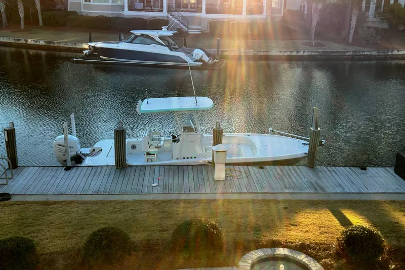Slide: The Image of 2021 Caymas 28 HB boat docked on a sunny waterfront. - 34