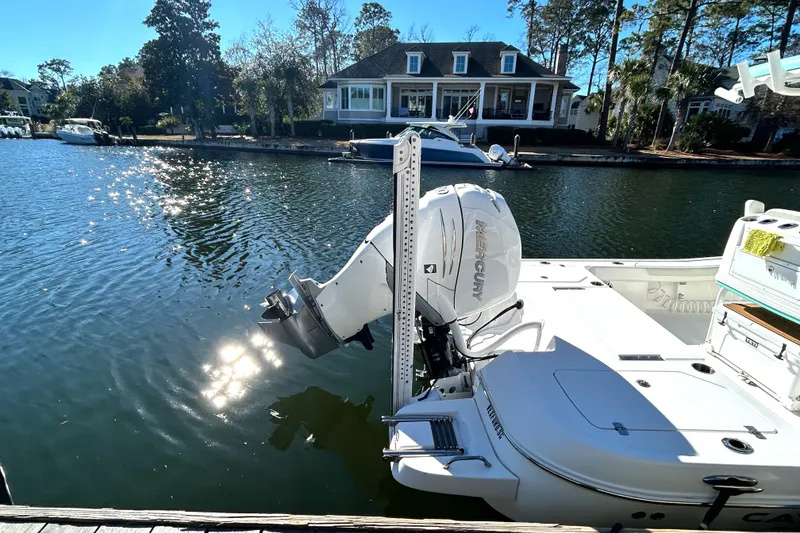 Slide: The Image of 2021 Caymas 28 HB boat docked by a scenic waterfront home. - 4