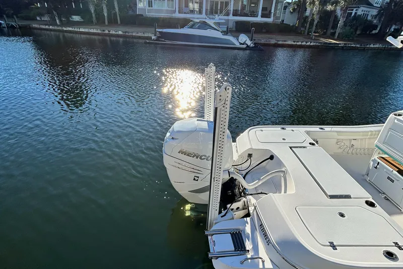 Slide: The Image of 2021 Caymas 28 HB boat with Mercury engine on calm water. - 5