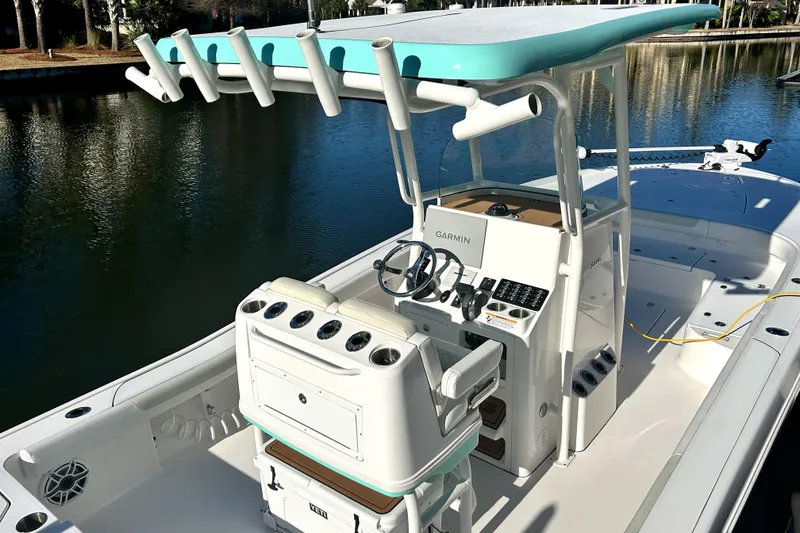 Slide: The Image of 2021 Caymas 28 HB boat with center console and rod holders on a calm waterway. - 9