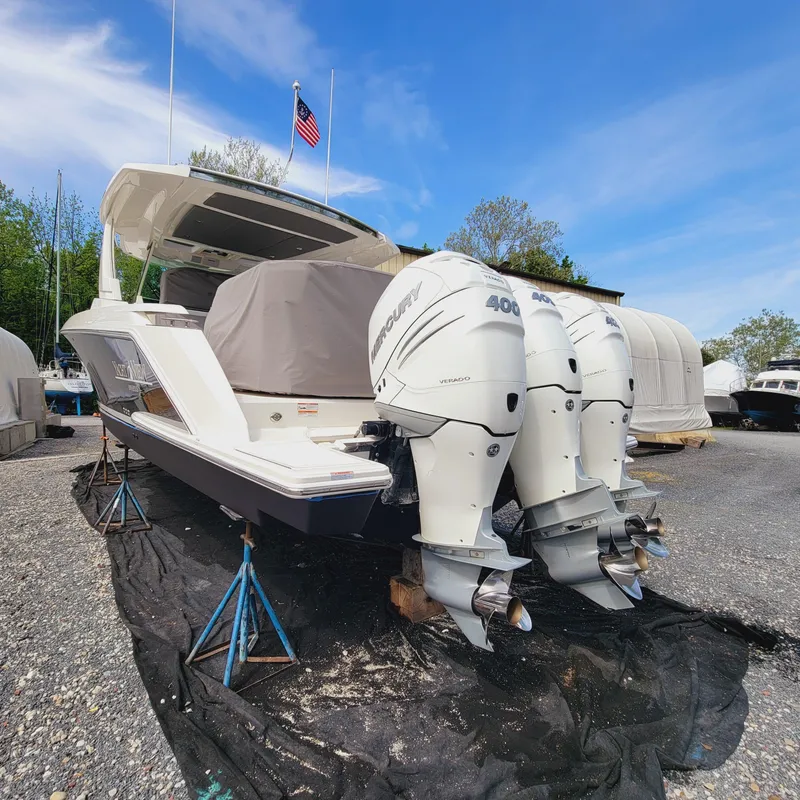 Slide: The Image of 2021 Tiara Yachts 38 LS with dual Mercury 400 engines on stands, under blue sky. - 29
