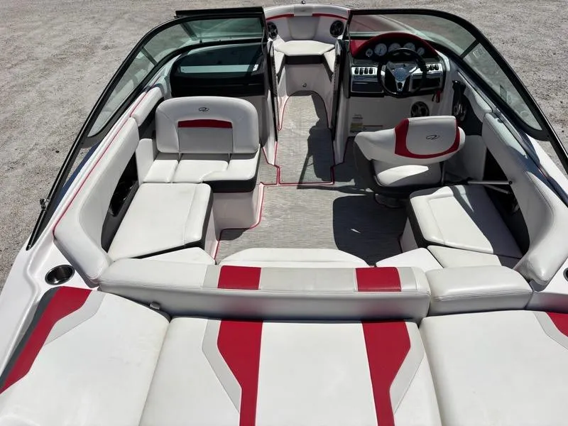 Slide: The Image of 2016 Regal 2000 ESX Bowrider interior with white and red seating, steering wheel, and dashboard. - 14