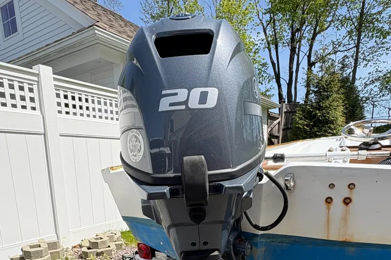 Slide: The Image of 1984 Boston Whaler 11 with a 20 HP outboard motor, parked outdoors. - 10