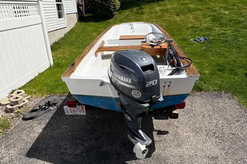Slide: The Image of 1984 Boston Whaler 11 with Yamaha 20 outboard motor on driveway. - 2