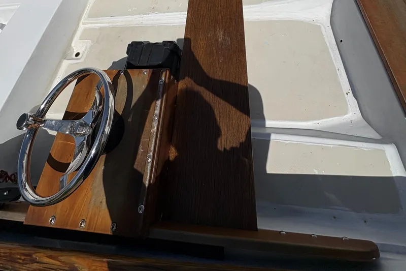 Slide: The Image of 1984 Boston Whaler 11 boat interior with wooden steering console and chrome wheel. - 7