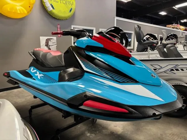 Slide: The Image of 2024 Yamaha WaveRunner VX Deluxe in blue and red, displayed indoors. - 1