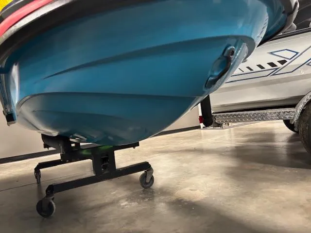 Slide: The Image of 2024 Yamaha WaveRunner VX Deluxe underside on a wheeled stand in a garage. - 12