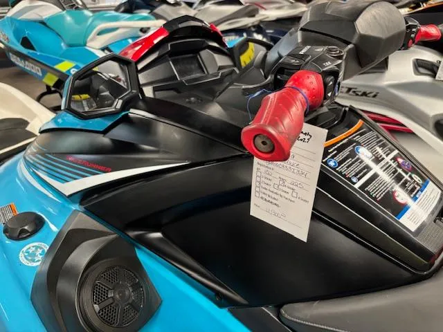 Slide: The Image of 2024 Yamaha WaveRunner VX Deluxe, blue and black, with red handle grips, displayed in showroom. - 8