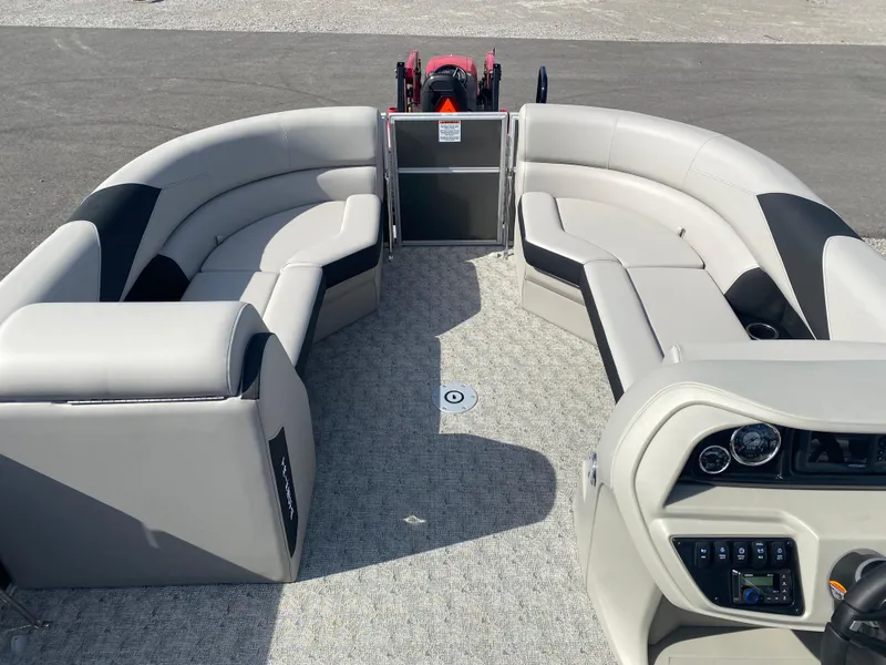Slide: The Image of 2025 Trifecta LE Series 22UL pontoon boat interior with plush seating and modern dashboard. - 10