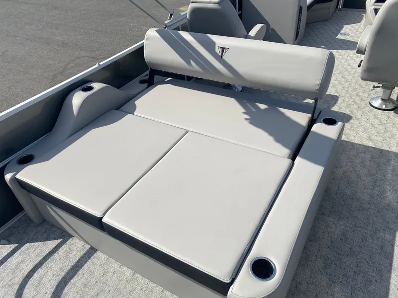 Slide: The Image of 2025 Trifecta LE Series 22UL boat seating with cup holders, featuring light gray upholstery. - 11
