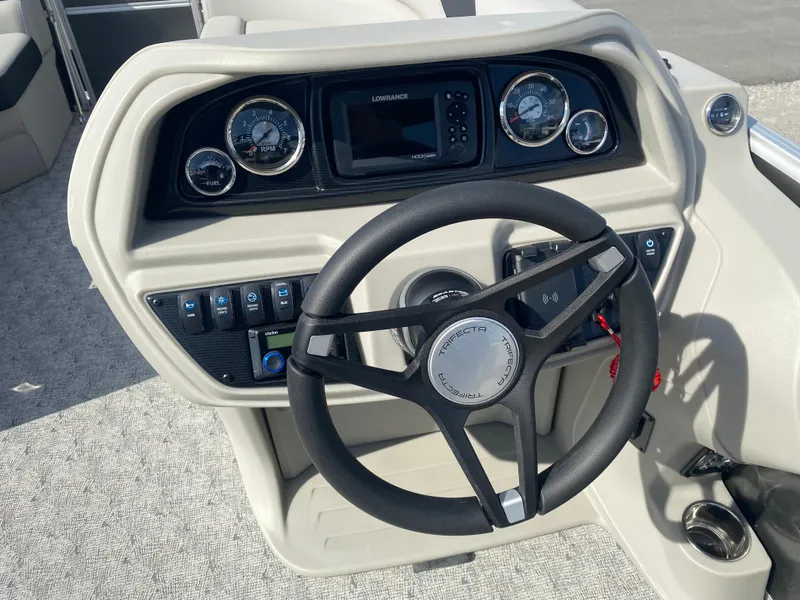 Slide: The Image of Steering console of 2025 Trifecta LE Series 22UL boat with gauges and controls. - 12