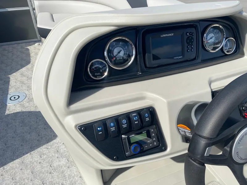 Slide: The Image of 2025 Trifecta LE Series 22UL dashboard with gauges and controls, featuring a Lowrance display. - 13