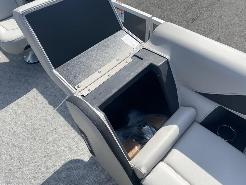 Slide: The Image of 2025 Trifecta LE Series 22UL boat seat storage compartment open, revealing interior space. - 15
