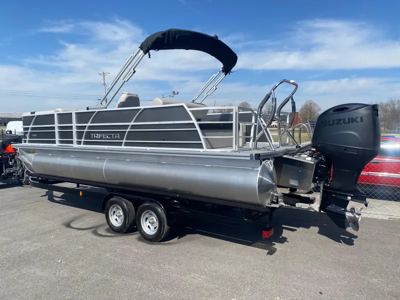Slide: The Image of 2025 Trifecta LE Series 22UL pontoon boat with Suzuki outboard motor on trailer. - 4