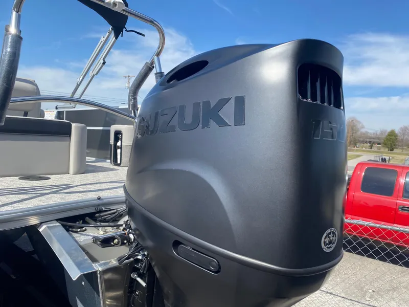 Slide: The Image of 2025 Trifecta LE Series 22UL boat with Suzuki outboard motor, parked outdoors. - 5