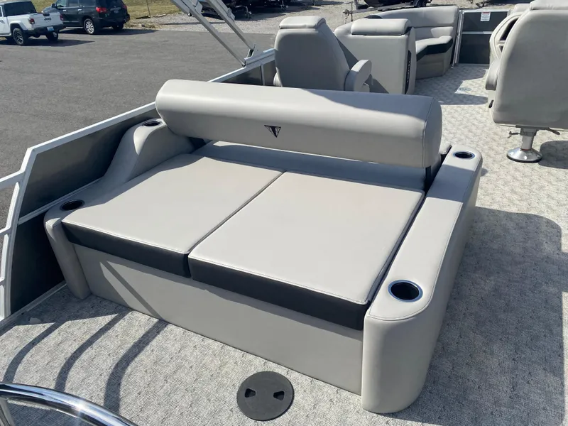 Slide: The Image of 2025 Trifecta LE Series 22UL pontoon boat with gray seating and cup holders. - 8