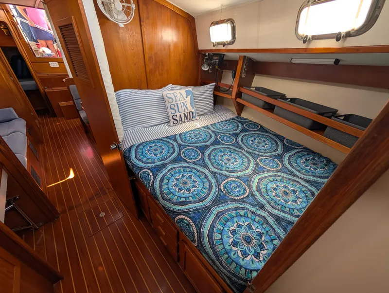 Slide: The Image of Cozy cabin interior of 1998 Caliber 40 LRC sailboat with patterned bedding. - 10