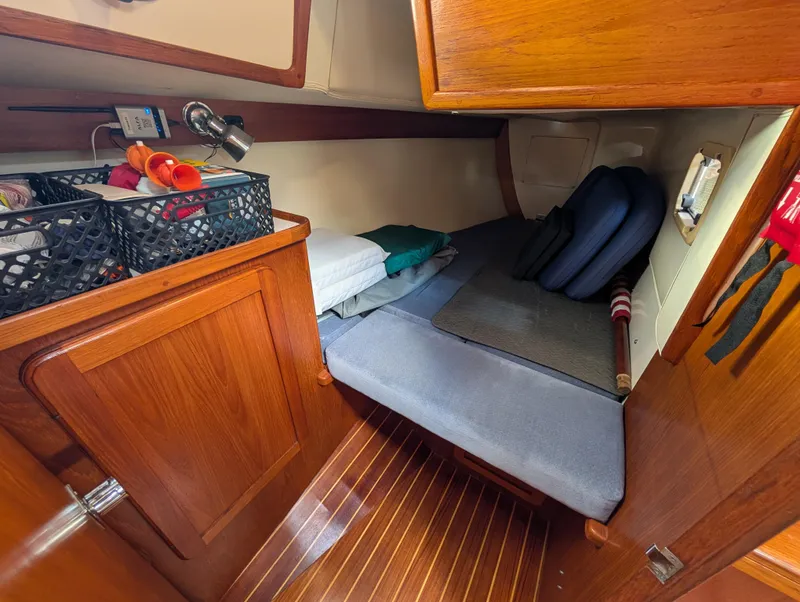 Slide: The Image of Cozy cabin interior of 1998 Caliber 40 LRC sailboat with wooden finish and storage. - 15